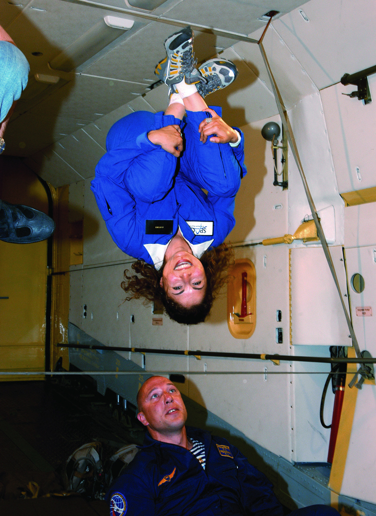 women upside down on international space station