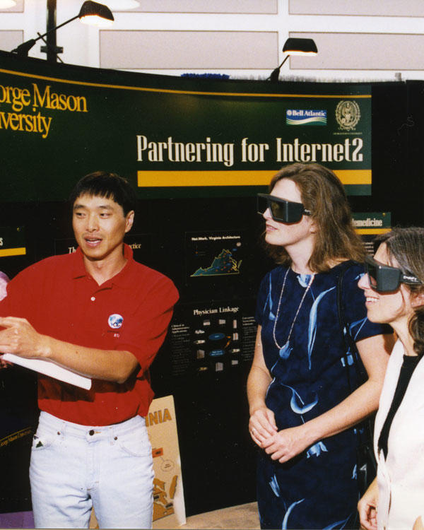 Students display and test virtual reality (VR) equipment at a poster session in the Johnson Center